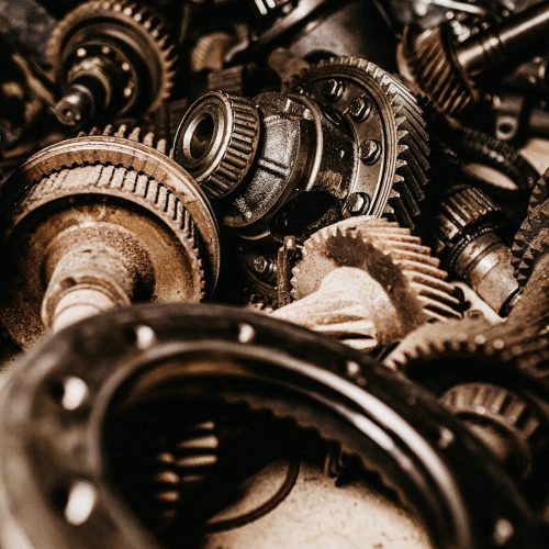 A vertical shot of grey, metallic gears, and car parts